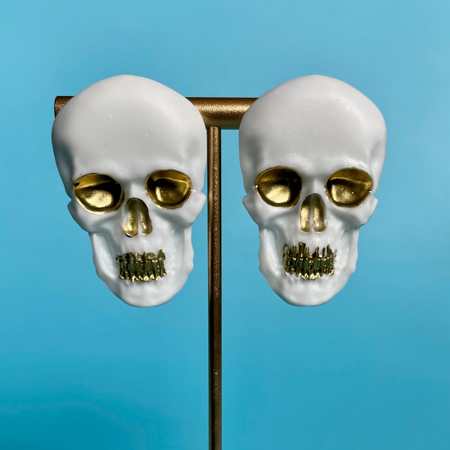 white & gold skull earrings