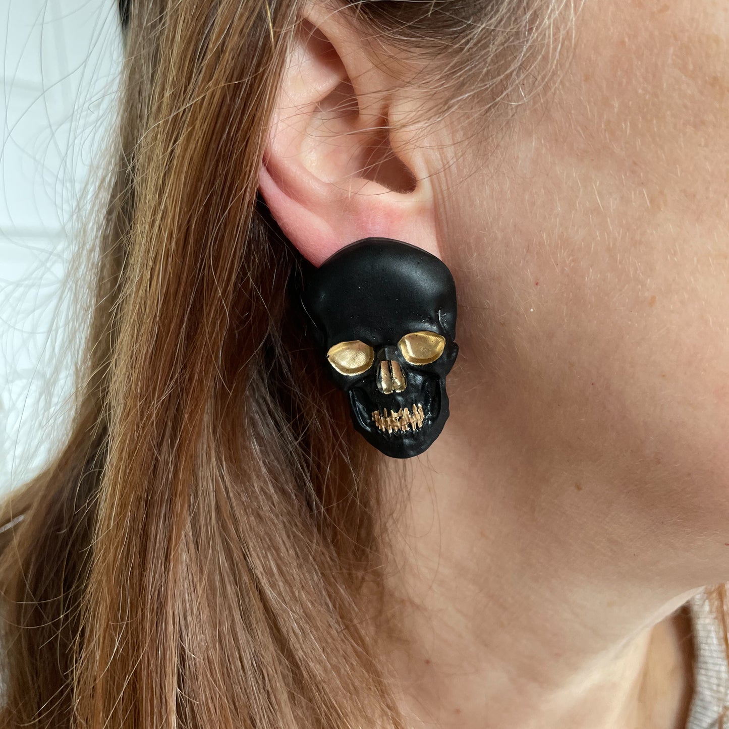 black & gold skull earrings