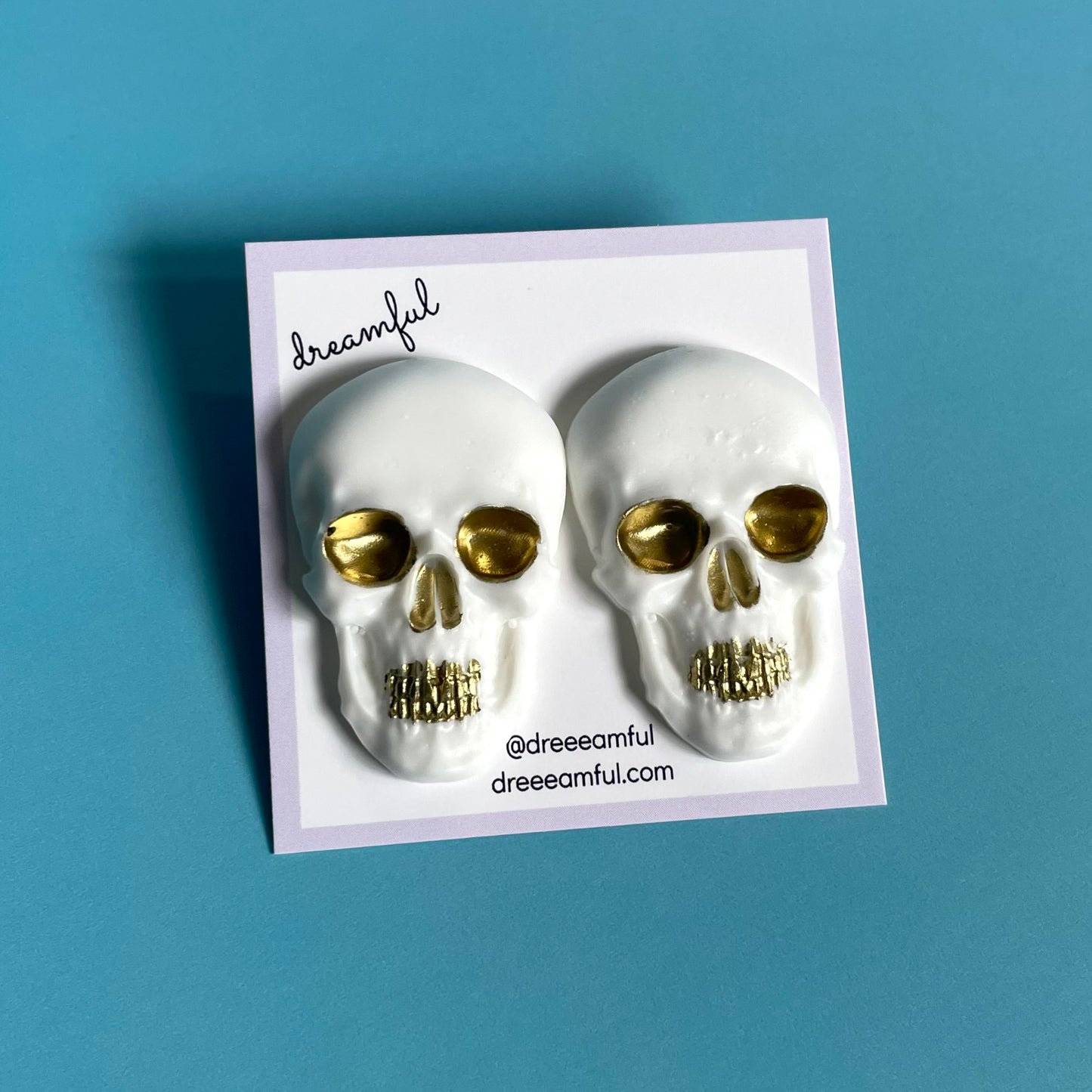 white & gold skull earrings